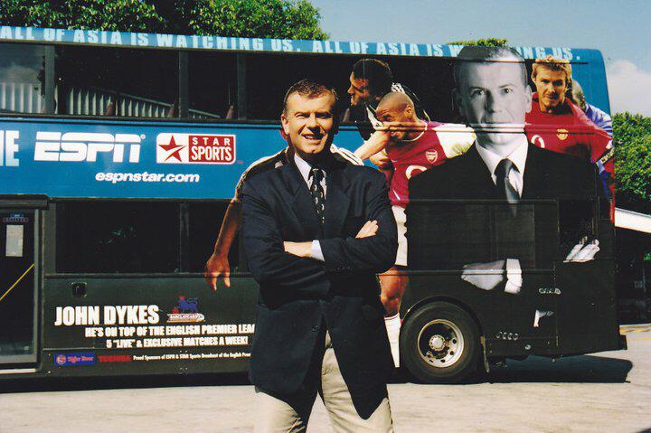 John Dykes in front of an ESPN bus with his picture on it